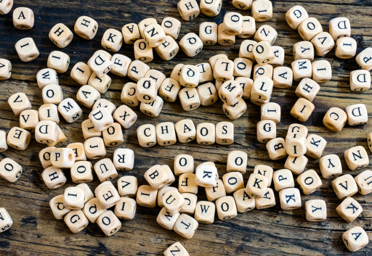 Wooden Dice With Letters In Disarray And The Word Chaos